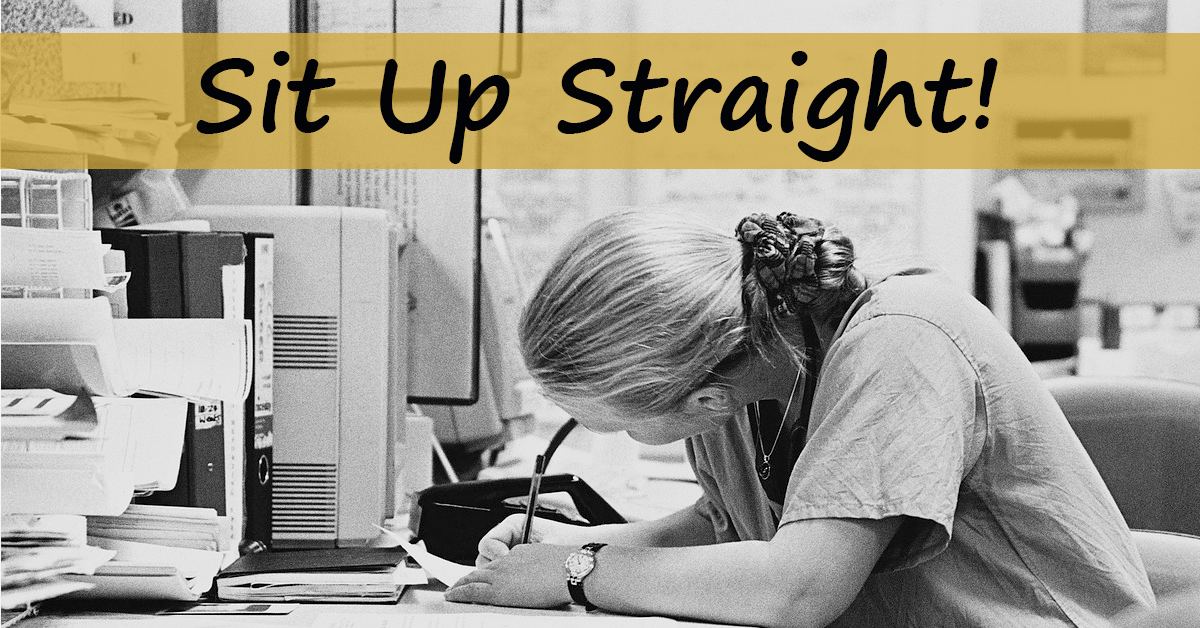 office worker slouching over their desk while working.