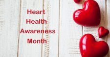 February is American Heart Month. Picture of red heart shaped bubbles laying on a piece of light colored paneling.