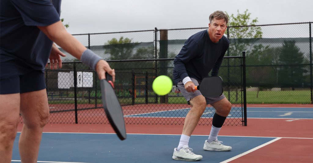 Senior men playing a game of Pickle Ball.