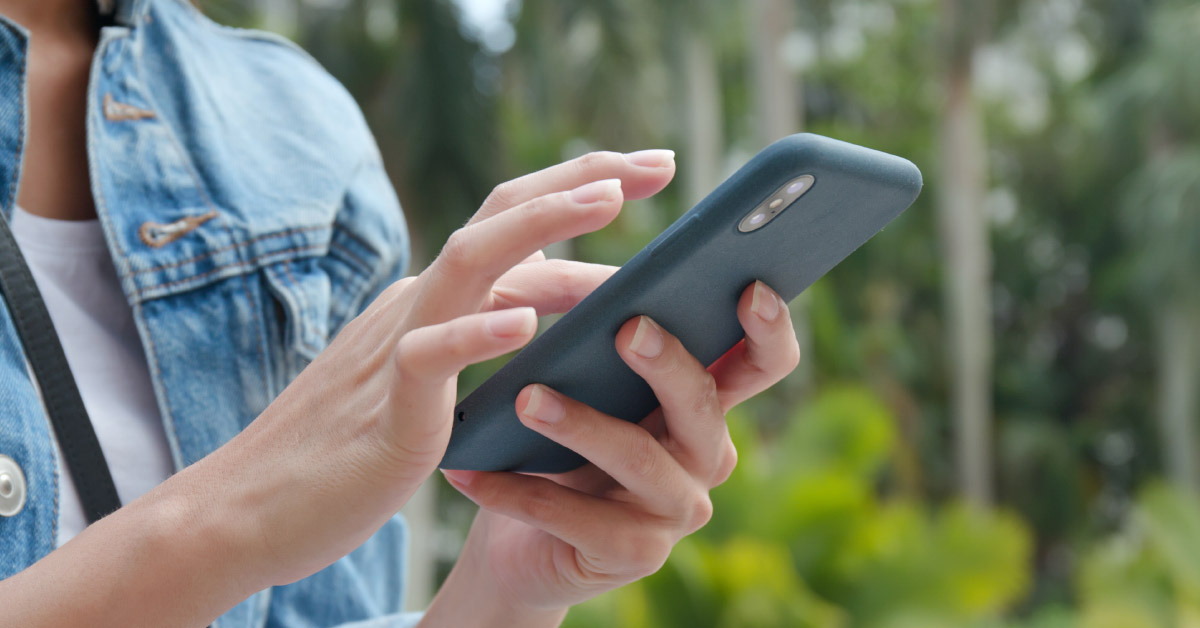 Lady sending a text on her smartphone